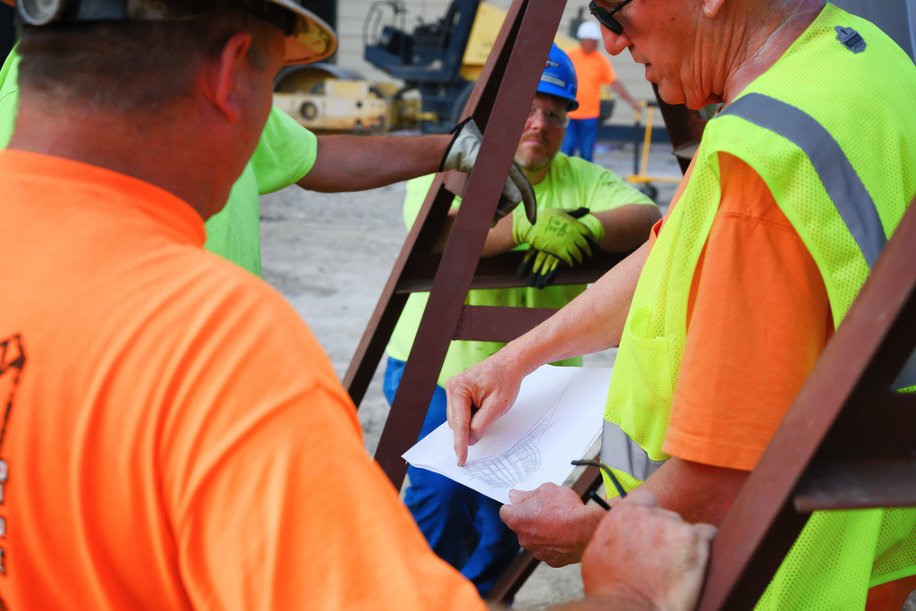 Construction Workers Installing Pharmacy Sculpture